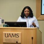 Leadership strategist and consultant Tish Bullard talks to UAMS students about how to build their personal brand in health care. Here, she's shown standing at a lectern during the seminar.