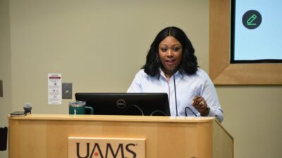 Leadership strategist and consultant Tish Bullard talks to UAMS students about how to build their personal brand in health care. Here, she's shown standing at a lectern during the seminar.