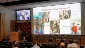 A woman stands behind a podium and delivers a talk.