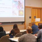 Maegan Calvert, Ph.D., talks to community members about her research that uses neuroimaging to better understand human behavior, predict treatment outcomes, and develop interventions.