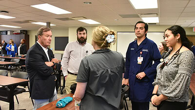 Dr. Barnes speaks to a group of family medicine residents