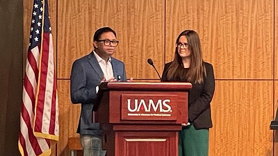image of Shitiz Sriwastava, M.D., and Erin Willis, M.D., at a UAMS lectern discussing MS Across the Lifespan