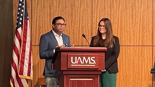 image of Shitiz Sriwastava, M.D., and Erin Willis, M.D., at a UAMS lectern discussing MS Across the Lifespan