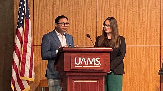 image of Shitiz Sriwastava, M.D., and Erin Willis, M.D., at a UAMS lectern discussing MS Across the Lifespan