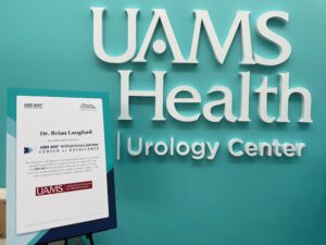 A close-up of the Center of Excellence proclamation in front of the UAMS Health Urology Center.