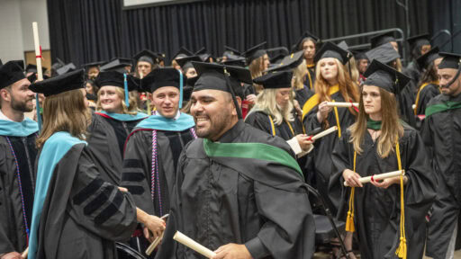 With diplomas in hand, new graduates of the College of Health Professions class of 2026 prepare to exit the Statehouse Convention Center after the commencement ceremony.