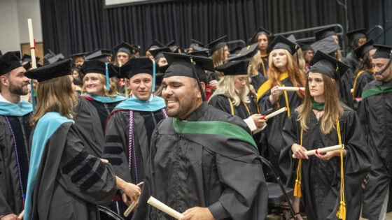 With diplomas in hand, new graduates of the College of Health Professions class of 2026 prepare to exit the Statehouse Convention Center after the commencement ceremony.
