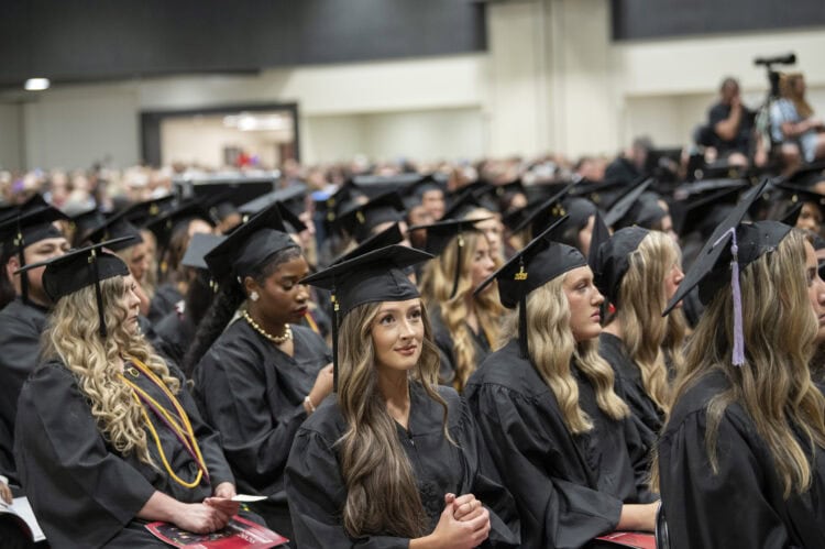 Soon-to-graduate students sit in the front rows of the audience just before the start of the commencement ceremony.