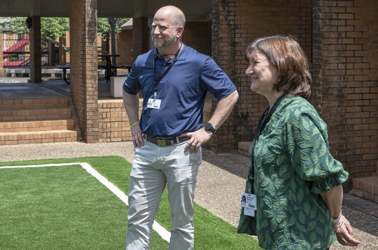 On May 8, Andy Davis, vice chancellor for External Affairs and Facilities Development, left, and Provost Stephanie Gardner joined the second-year PA students celebrate the new turfed volleyball court.