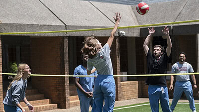 Physician Assistant Studies students play volleyball on the new court surface..