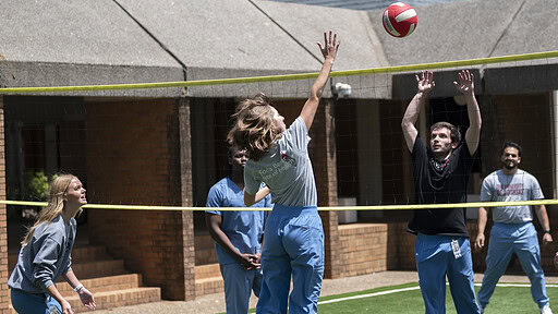 Physician Assistant Studies students play volleyball on the new court surface..