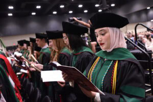 Medical students on the verge of becoming doctors recite the Hippocratic oath.