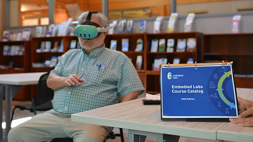 Doug Thompson, a reporter with the Northwest Arkansas Democrat Gazette, tries out a virtual reality headset that simulates the dementia experience.