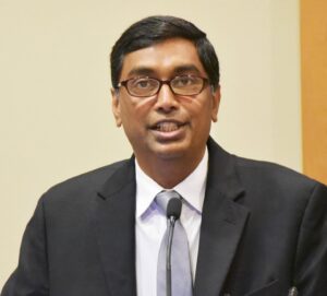 Dr. Shashank Kraleti speaks from behind podium