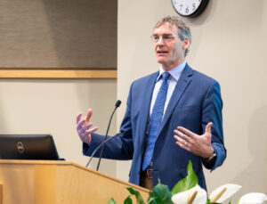 Dr. David Rakel speaks from behind the podium