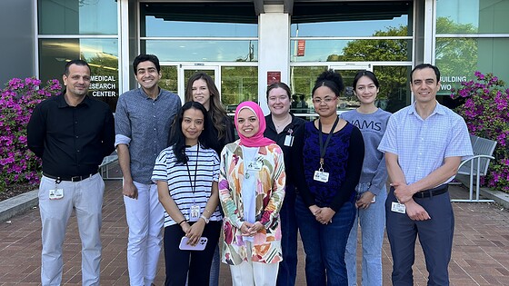Abdel Fouda, Ph.D., right, and members of his laboratory, standing outside.