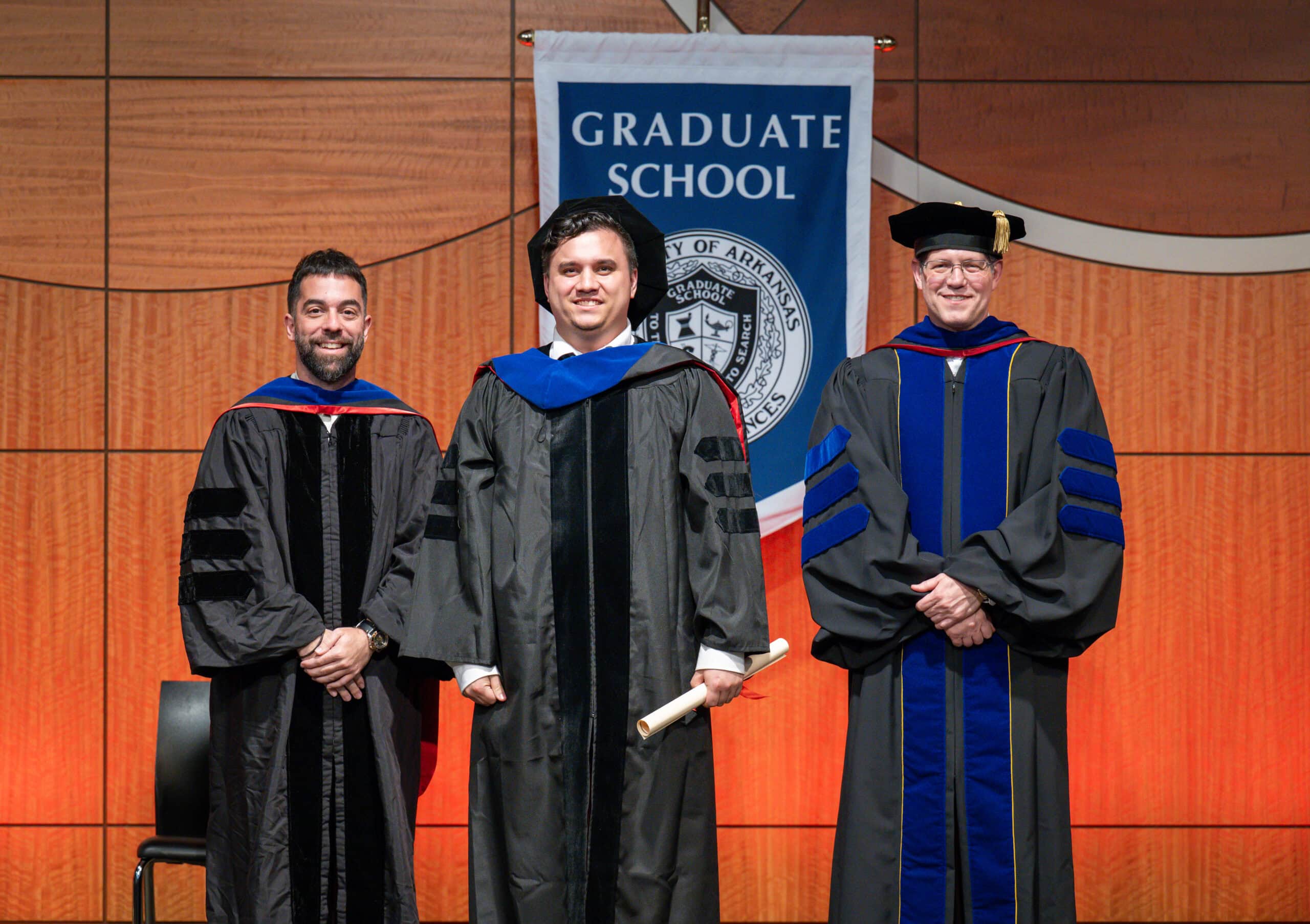 Aric Anloague, Jesus Delgado-Calle, Ph.D., and Graduate School Dean Sean Taverna, Ph.D.,