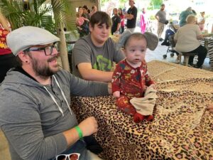 Dustin Barker of Paragould celebrates his son Malachi's NICU graduation as Malachi wears elephant ears.