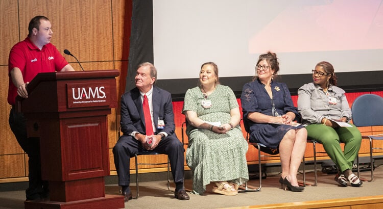 Keynote speaker Marshall Neal, left, speaks as Chancellor Barnes, seated right, Rebecca Seljan, Dana Byrum and Patrice Storey.