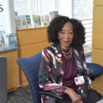 Susie Whittington sits at the front desk in the lobby of the UAMS Donald W. Reynolds Institute on Aging, where she directs patients to their appointments and offers words of encouragement and comfort.