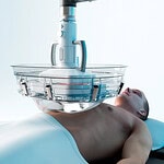 stock image of patient with histotripsy machine hovering over his chest before a procedure