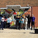 Members of the UAMS Institute for Community Health Innovation conduct a ribbon cutting for a smart food locker.