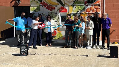 Members of the UAMS Institute for Community Health Innovation conduct a ribbon cutting for a smart food locker.