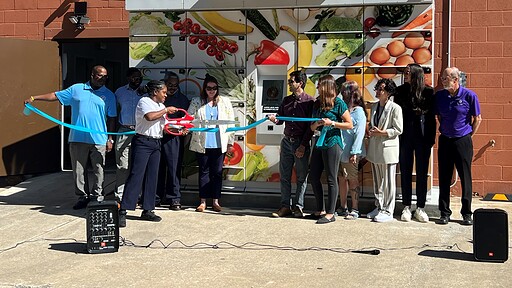 Members of the UAMS Institute for Community Health Innovation conduct a ribbon cutting for a smart food locker.
