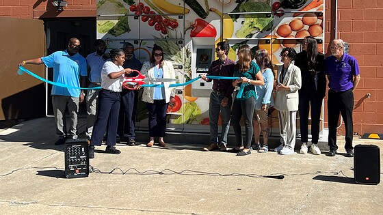 Members of the UAMS Institute for Community Health Innovation conduct a ribbon cutting for a smart food locker.