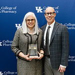 UAMS College of Pharmacy Dean Cindy Stowe and University of Kentucky College of Pharmacy Interim Dean Craig Martin pose for a photo with Stowe's Hall of Distinguished Alumni award