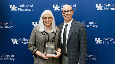 UAMS College of Pharmacy Dean Cindy Stowe and University of Kentucky College of Pharmacy Interim Dean Craig Martin pose for a photo with Stowe's Hall of Distinguished Alumni award