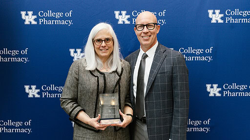 UAMS College of Pharmacy Dean Cindy Stowe and University of Kentucky College of Pharmacy Interim Dean Craig Martin pose for a photo with Stowe's Hall of Distinguished Alumni award