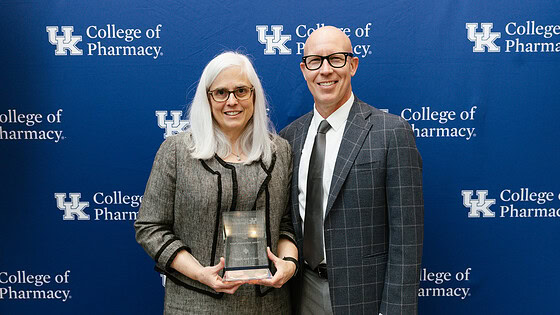 UAMS College of Pharmacy Dean Cindy Stowe and University of Kentucky College of Pharmacy Interim Dean Craig Martin pose for a photo with Stowe's Hall of Distinguished Alumni award