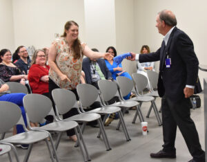 Marjorie Hudson, M.D., gets a t-shirt from Dr. Barnes for asking about the maternal health gap.