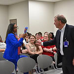Barnes hands t-shirt to Mattlene Miller
