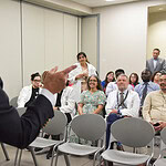 Barnes points to someone in the audience as Kristina Patel, M.D., asks questions