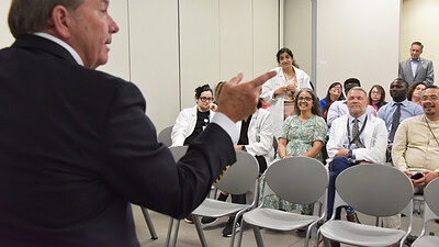 Barnes points to someone in the audience as Kristina Patel, M.D., asks questions