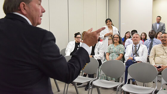 Barnes points to someone in the audience as Kristina Patel, M.D., asks questions