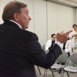 Barnes points to someone in the audience as Kristina Patel, M.D., asks questions