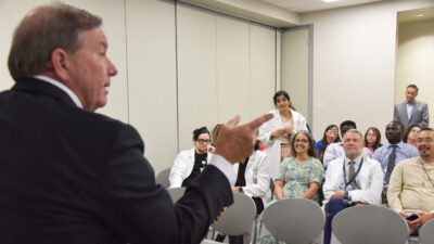 Barnes points to someone in the audience as Kristina Patel, M.D., asks questions