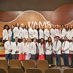 The PA Class of 2028 gather for a group photo following the white coat ceremony that officially inaugurates their course of study.