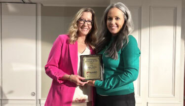 Arkansas Academy of Nutrition and Dietetics President Danya Arnold, right, presents to Lesley Jones the Outstanding Dietitian of the Year award.