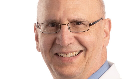 white-coat portrait of Paul Drew, Ph.D.