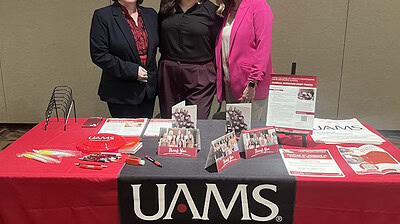Jennifer Clampit, left, Courtney Fose and Lesley Jones stop for a moment behind the recruitment table at the Arkansas Academy of Nutrition and Dietetics Annual Meeting and Exhibits.