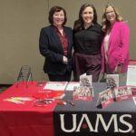 Jennifer Clampit, left, Courtney Fose and Lesley Jones stop for a moment behind the recruitment table at the Arkansas Academy of Nutrition and Dietetics Annual Meeting and Exhibits.