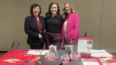 Jennifer Clampit, left, Courtney Fose and Lesley Jones stop for a moment behind the recruitment table at the Arkansas Academy of Nutrition and Dietetics Annual Meeting and Exhibits.