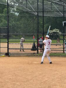 Eliezer Villaneueva, M.D., at bat on a Central Park ball field.