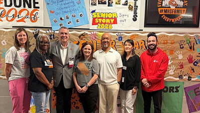 Roger Swayze, RN, a cardiac nurse at UAMS (in suit) poses with representatives of the school and the American Heart Association.