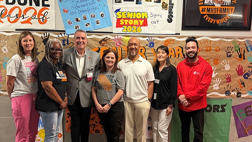 Roger Swayze, RN, a cardiac nurse at UAMS (in suit) poses with representatives of the school and the American Heart Association.