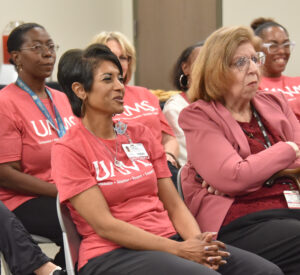 Phlebotomist Regina Johnson laughs as Barnes describes her position as a possible launchpad for patient growth.